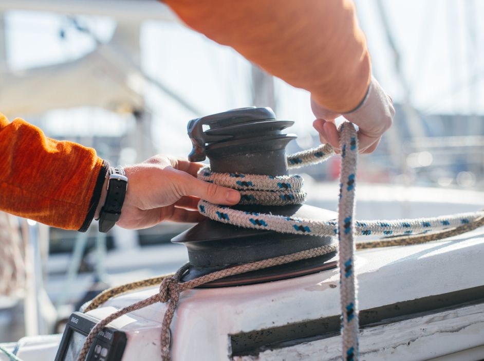 Sailors working with rigging on the deck of a ship, demonstrating practical skills of the maritime profession